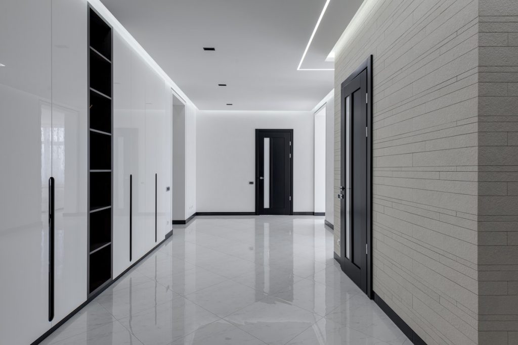 Big hall in minimalistic style in modern apartment building